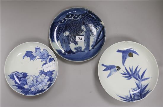Three Nabeshima style blue and white dishes, figural dish diameter 21cm